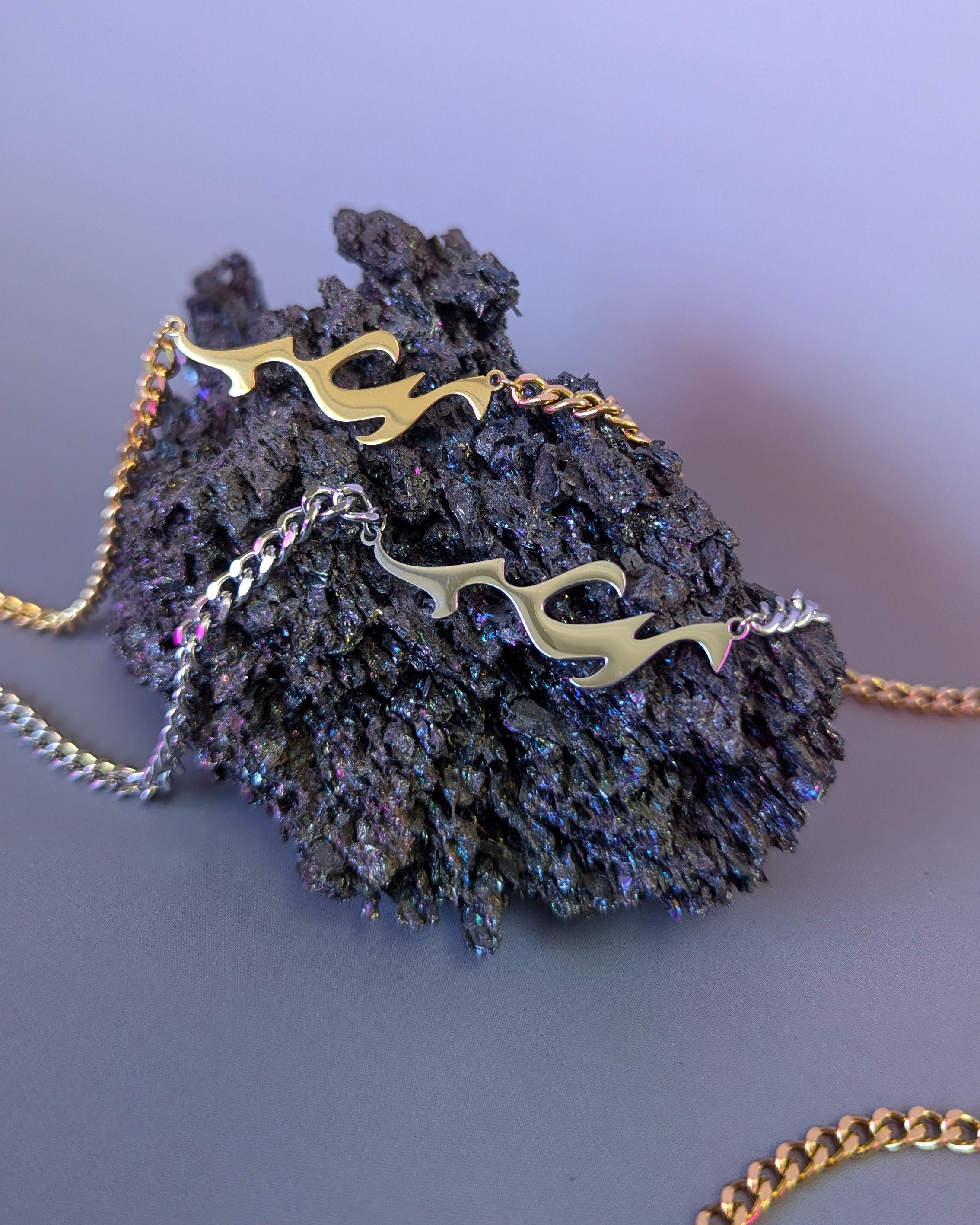 Necklace with gold chain and decorative elements on a purple background